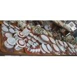 Seven trays of Noritake porcelain tea and dinnerware items on a white ground with burgundy and