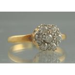 A DIAMOND FLOWERHEAD CLUSTER RING. The s