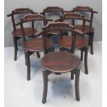 A SET OF SIX 20TH CENTURY HARDWOOD CHAIRS having bentwood and carved backs on moulded circular seat,
