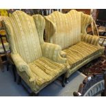 Queen Anne style upholstered two seater wing sofa with scroll over arms and loose cushion on