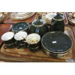 Tray of French Apilco pottery teaware on a green and gilded ground,