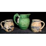 Wedgwood green glazed relief moulded jug depicting hunting scenes,