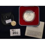 Gold half sovereign dated: 1911, together with a 1977 Queen's Silver Jubilee crown in original box.