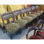 A set of six Victorian walnut side chairs having carved foliate and lyre back decoration with stuff