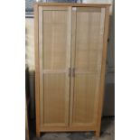 Oak finish modern two door blind panelled wardrobe, together with pair of matching bedside cabinets.