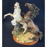 Continental study of two rearing horses on naturalistic base and wooden plinth,