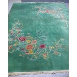 Mid 20th Century Chinese wash carpet piled and decorated with naturalistic flowers and scroll work,