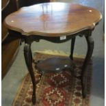 Edwardian mahogany occasional table of oval piecrust form with under tier, on outswept carved legs.