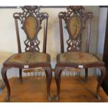 Pair of Edwardian stained and carved padded back upholstered serpentine front chairs on cabriole