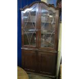 Early 19th Century mahogany two stage corner cabinet, having shaped moulded cornice,