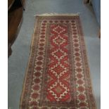 Middle Eastern design runner on a cream and red ground with a central geometric field. (B.P.