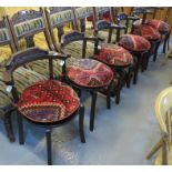 A set of six 20th Century hardwood chairs having bentwood and carved backs on moulded circular seat,