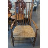 Early 20th Century mahogany low slat back armchair on rush seat. (B.P. 24% incl.