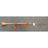 A copper and brass horn with tassel. (B.P. 24% incl.