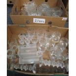 Two boxes of assorted glassware to include; glass candlesticks, candle holders, flower shaped bowls,