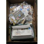 Box of All World stamps in various packets and envelopes and shoebox of First Day Covers and stamp