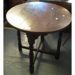 Mid 20th Century oak circular occasional table with 'X' stretcher support. (B.P. 24% incl.