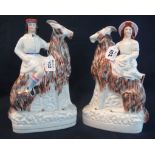 Pair of 19th Century Staffordshire flat backs of figures seated on stylised goats or rams. (B.P.