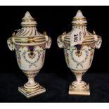 Pair of Dresden porcelain urn shaped lidded vases on a white ground with gilded and swag floral and