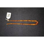A string of amber type beads. (B.P. 24% incl.