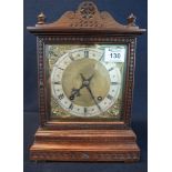 Early 20th Century carved oak, two train mantel clock with key and pendulum,