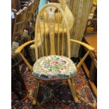 Ercol beech rocking chair, the hoop back centred with a carved swan motif. (B.P. 24% incl.