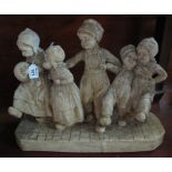 Plaster novelty figural group of children at play on naturalistic base. (B.P. 24% incl.