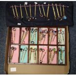 Two trays of vintage bone lace bobbins with coloured stones, all in fitted trays. (B.P. 24% incl.