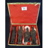 Set of four Chinese ceramic figurines of the terracotta army in a cloth covered presentation box.