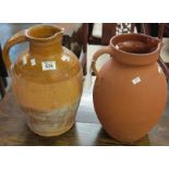 Two similar terracotta single handled jugs or pots. (2) (B.P. 24% incl.