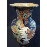Oriental style ceramic floor vase of baluster form decorated with dragons amongst clouds. (B.P.
