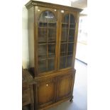 Early 20th Century oak two door glazed bookcase on pad feet. (B.P. 24% incl.