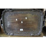 Carved hardwood two handled tray overall with foliate decoration. (B.P. 24% incl.