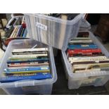 Eight plastic boxes of assorted books, hard backs etc.