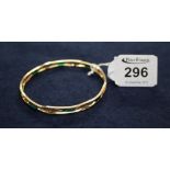 A 9ct gold open work bangle with green beads. 10g approx. (B.P. 24% incl.