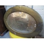 A large Arts & Crafts design beaten copper bevel plate oval mirror. (B.P. 24% incl.