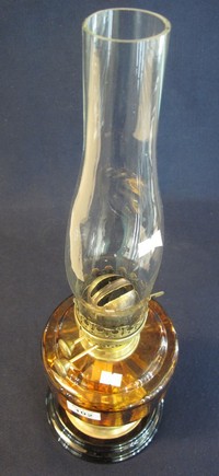 Early 20th Century brass double burner oil lamp with amber glass reservoir on brass pedestal with