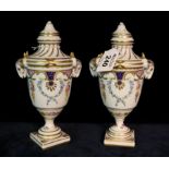 Pair of Dresden porcelain urn shaped lidded vases on a white ground with gilded and swag floral and