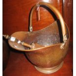 Brass helmet shaped coal scuttle with swing handle and shovel. (B.P. 24% incl.