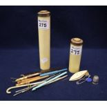 Two simulated ivory hat pin cylindrical boxes with gilt metal covers,