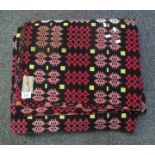 Vintage woollen Welsh tapestry blanket with geometric design on black ground and 'All pure wool,