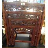 Oriental hardwood quartetto nest of four tables with pierced frieze of birds amongst foliage. (B.P.