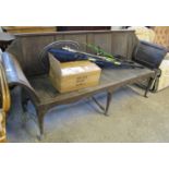 Distressed oak bench of large proportions with four fielded panels to the back, shaped arms,