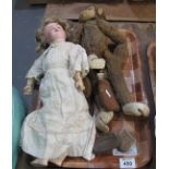 Vintage straw filled monkey with moveable limbs, together with a German porcelain headed doll,