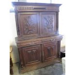 17th Century style heavily carved oak two stage blind panelled cupboard on stand. (B.P. 24% incl.