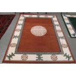 Large modern carpet on a multi-coloured geometric ground,