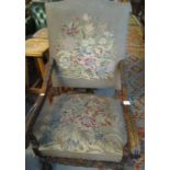 Late 19th/early 20th Century carved oak high back open armchair with tapestry floral upholstery.