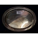 Small silver gadroon edged oval shaped presentation salver on four paw feet,