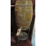 19th Century glazed stoneware armorial barrel with wooden tap, on a pierced brass jardiniere stand.