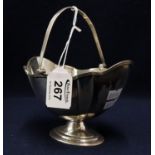 Silver boat shaped pedestal sucrier with reeded swing handle.